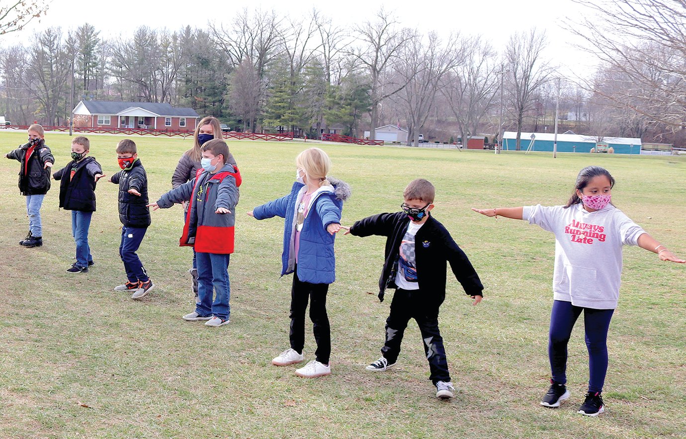 Second-grade students at Sommer Elementary continue following social distancing guidelines and mask regulations as they head outside Friday on a mild December afternoon.
